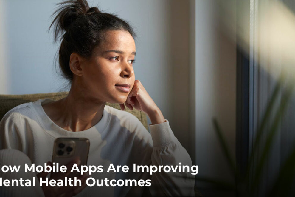 How Mobile Apps Are Improving Mental Health Outcomes Woman looking out window while holding her phone
